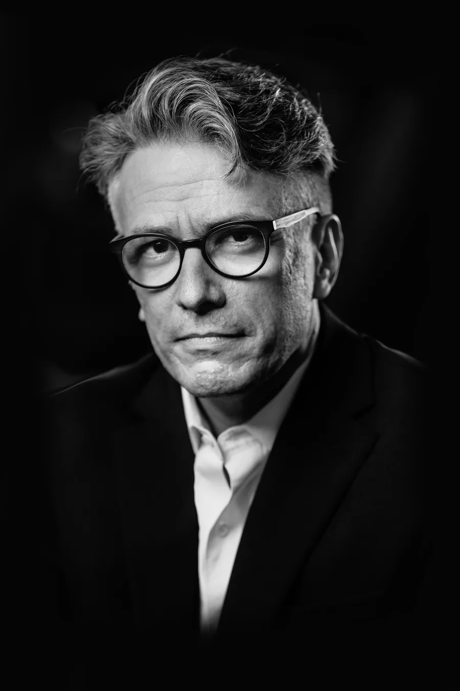 Black-and-white portrait of Felipe Csaszar in a dark jacket and white shirt
